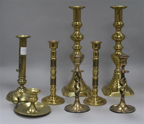 Three pairs of brass candlesticks, another and a candlestick holder